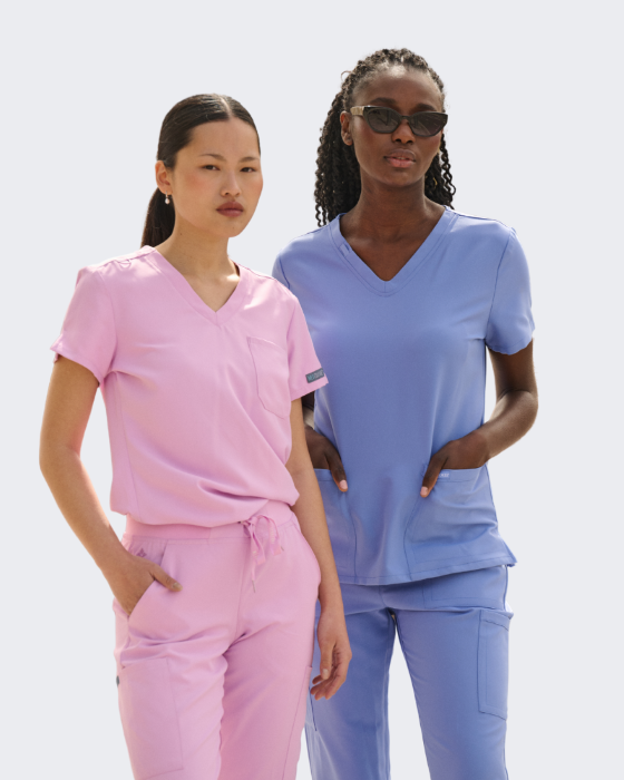 Two women wearing pink and blue scrubs from the med couture collection