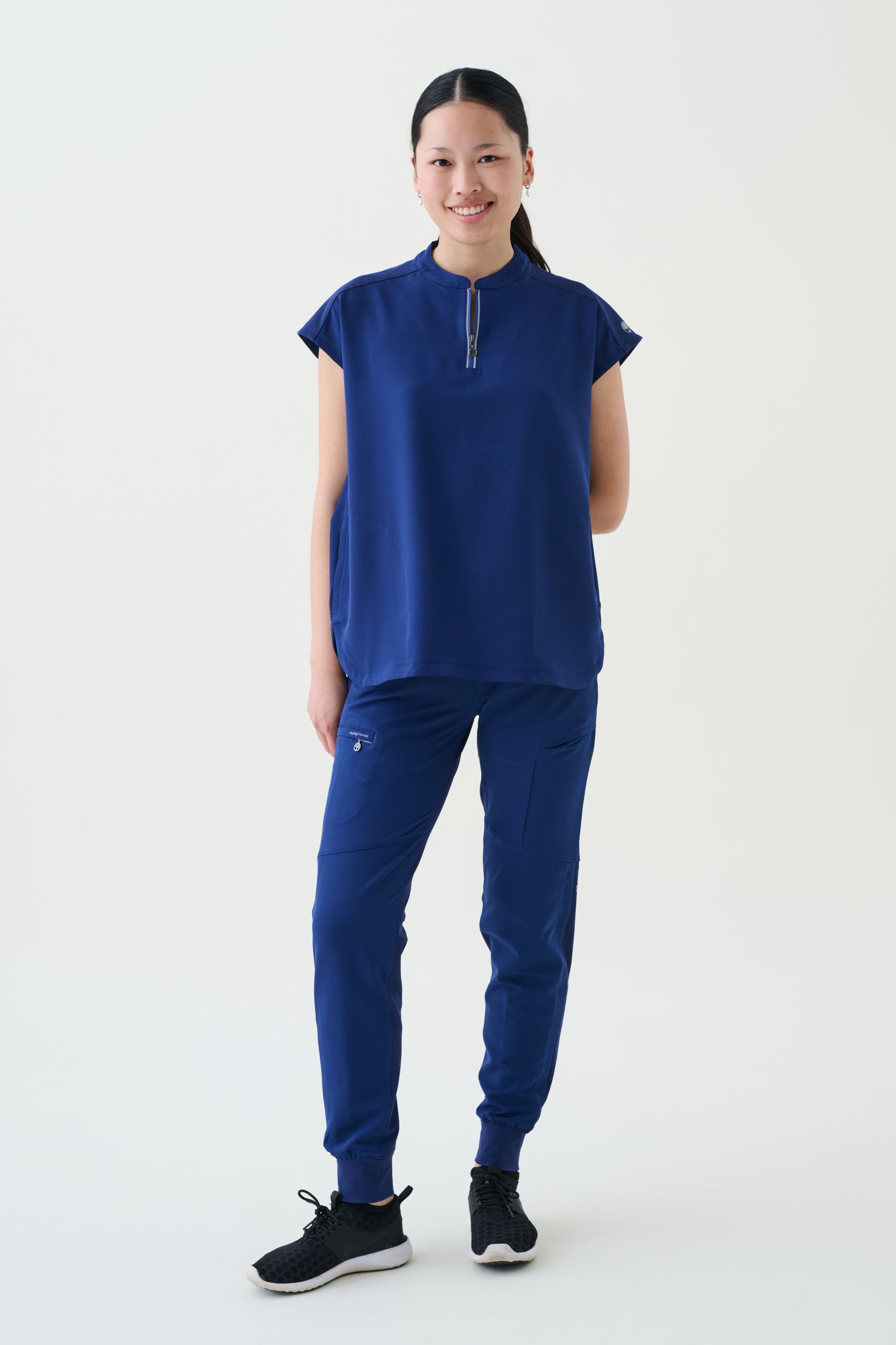 Person wearing a navy outfit on a white background